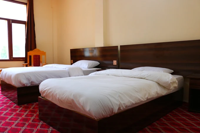 “Comfortable hotel room with two large beds and a window overlooking the mountains.”